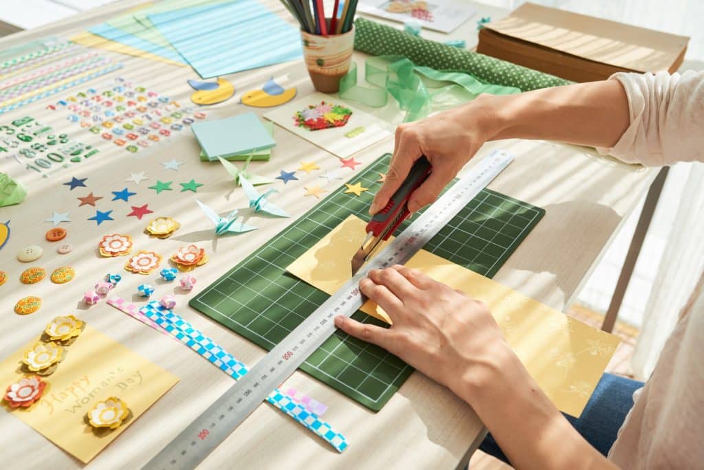Creative Woman Concentrated on Scrapbooking