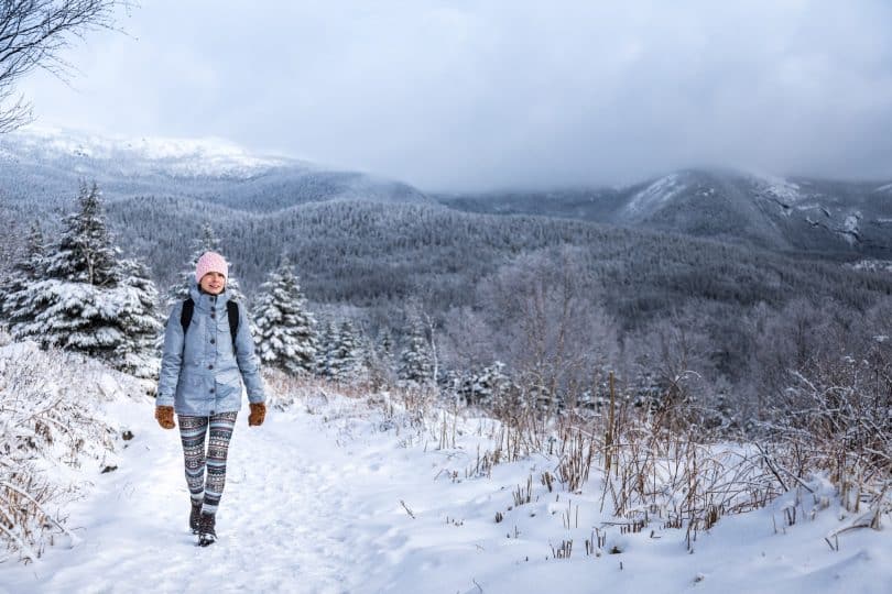 Woman Hiking High in the Mountains during Winter