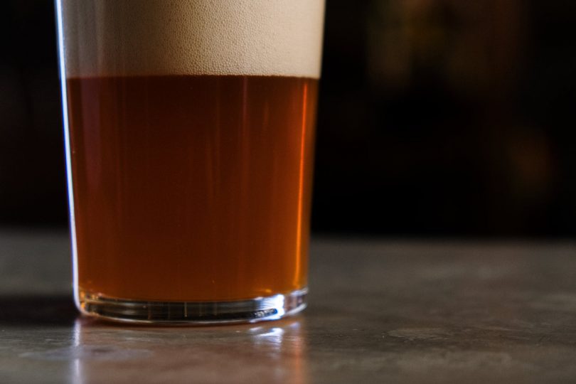 clear drinking glass with brown liquid