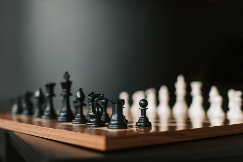 black chess pieces on chess board
