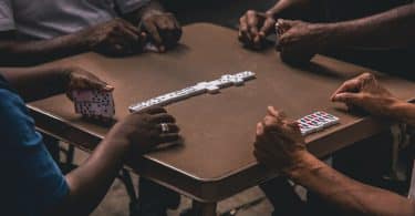 a group of people playing the dominoes game