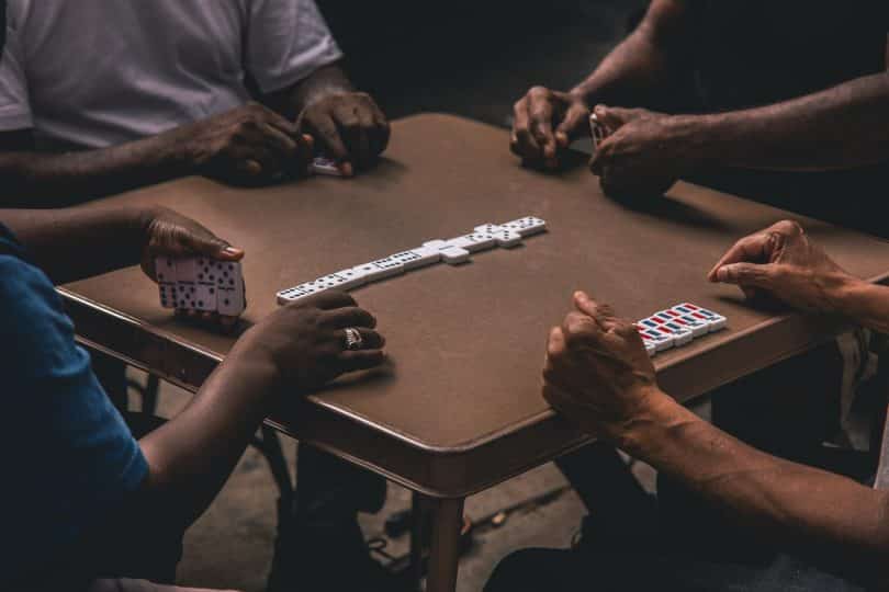 a group of people playing the dominoes game