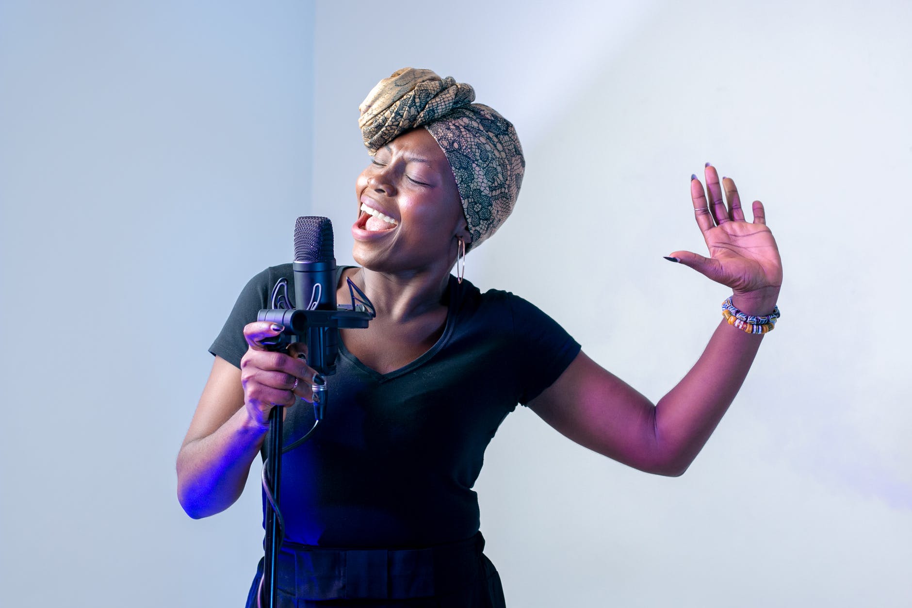 photo of woman singing in music studio