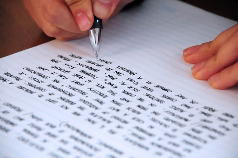 A person writing on paper