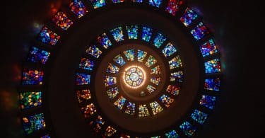 worms eye view of spiral stained glass decors through the roof