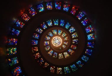 worms eye view of spiral stained glass decors through the roof