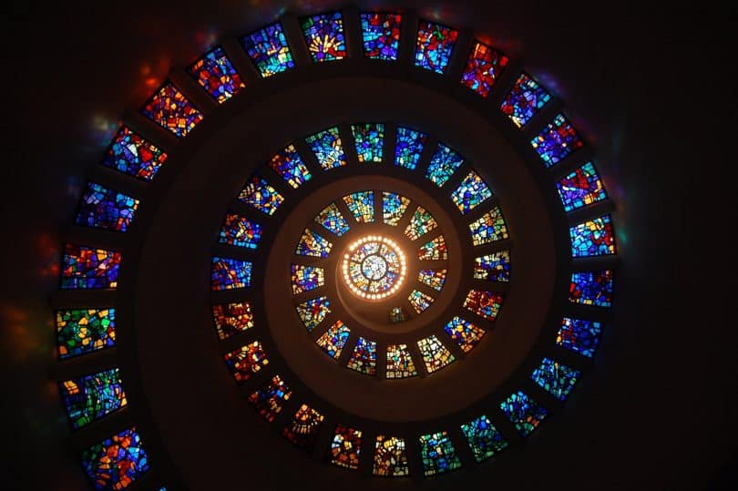 worms eye view of spiral stained glass decors through the roof