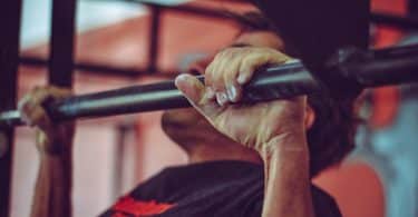 man in black crew neck shirt doing pull ups