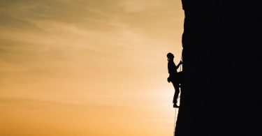 person rock climbing