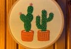 hand embroidered cactus design on wooden wall