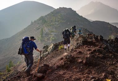 group of person walking in mountain