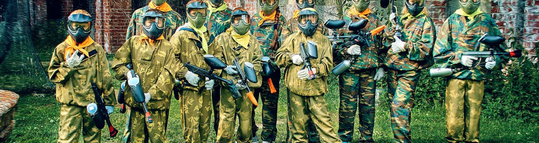 people in a military uniform holding paintball guns