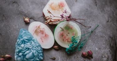 set of creative handmade soaps placed on table with dried plants