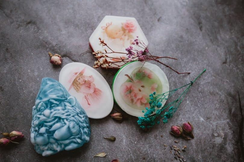 set of creative handmade soaps placed on table with dried plants